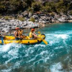 A group of people riding on the back of a raft